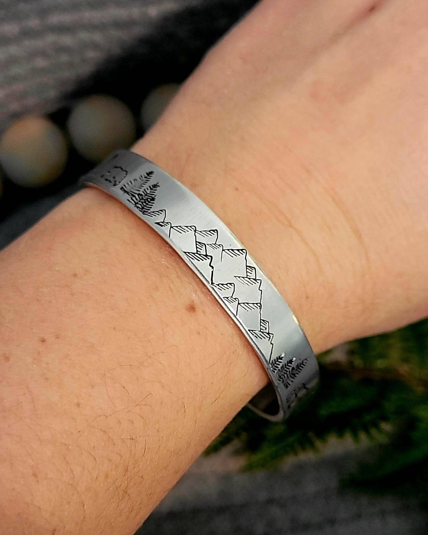 Hand stamped mountain scene aluminum cuff