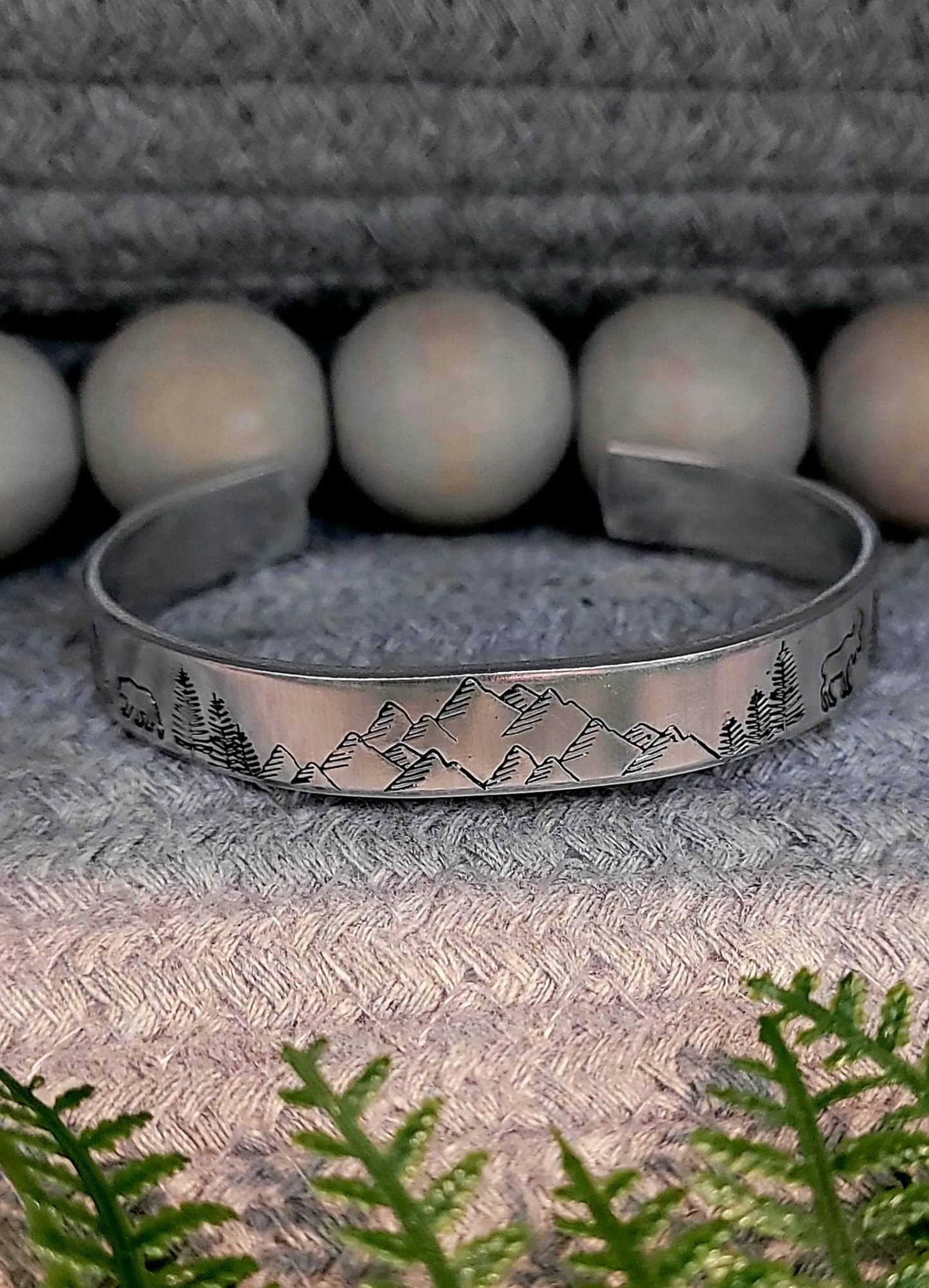 Hand stamped mountain scene aluminum cuff